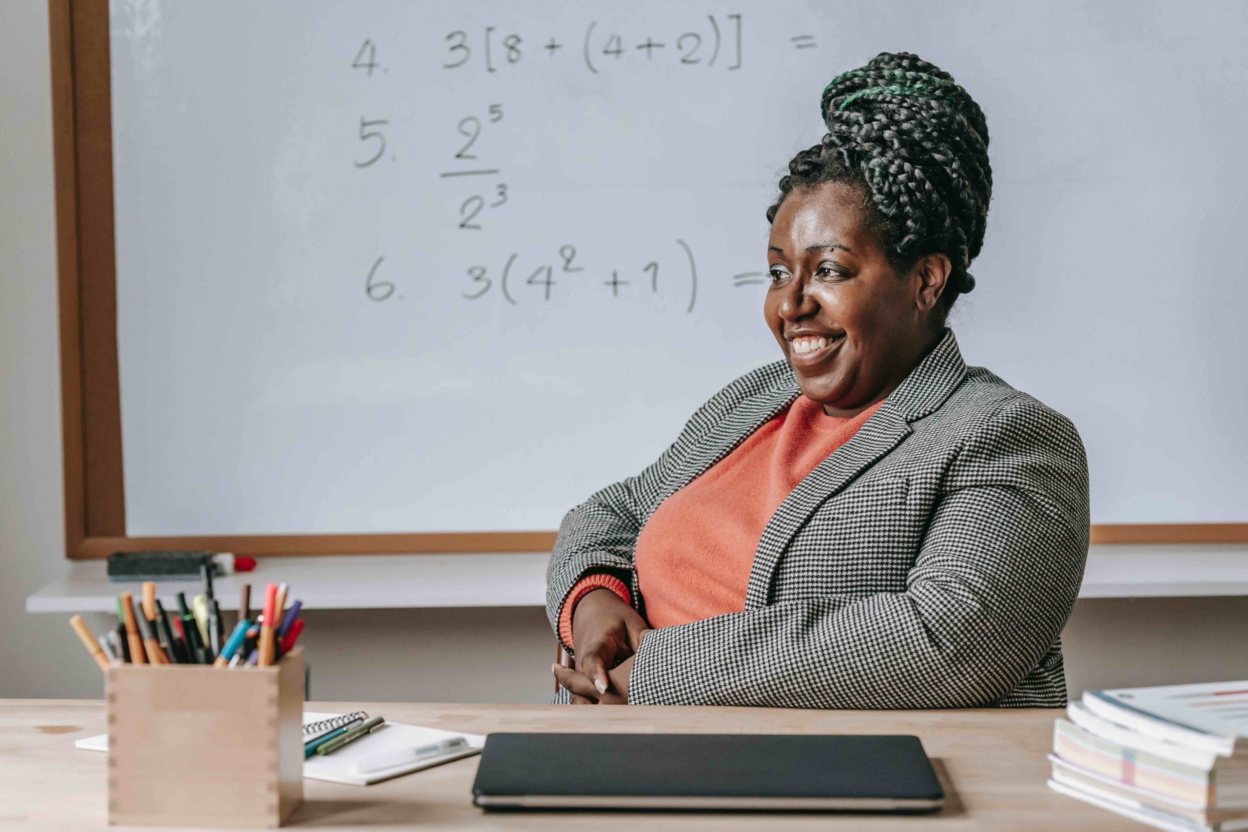 Happy teacher in classroom