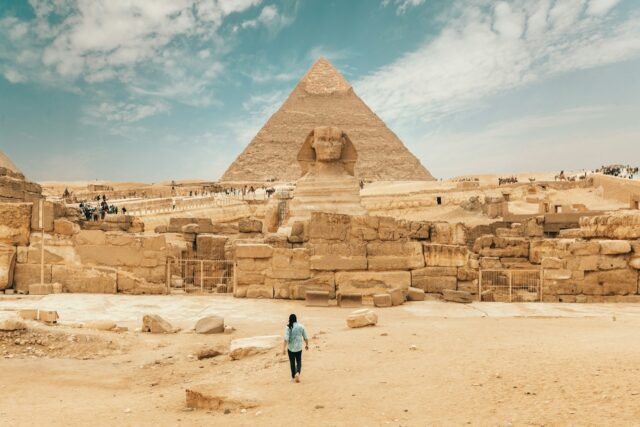 Sphinx and pyramid in desert landscape