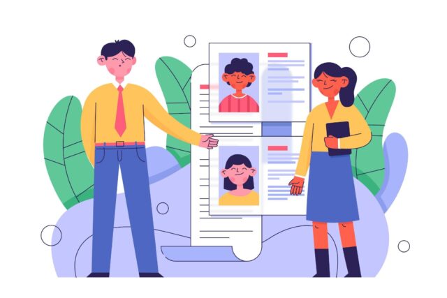 Two people reviewing resumes together.