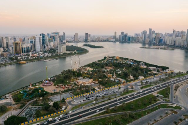Panoramic view of the Dubai Marina skyline and Ain Dubai Ferris wheel at sunset.