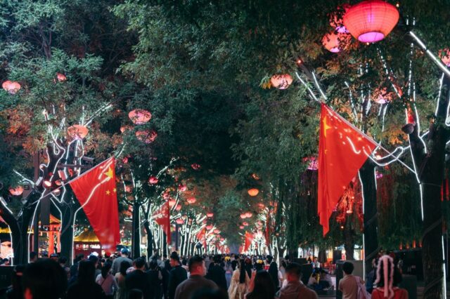 Teaching in China - Red lanterns and Chinese flags illuminating a bustling street market 