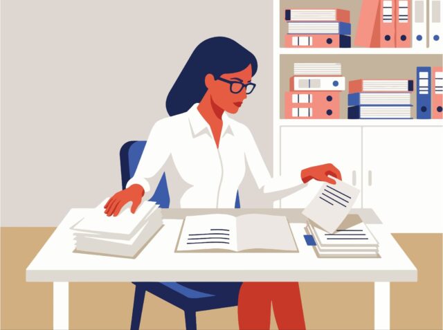 Woman organising papers at desk