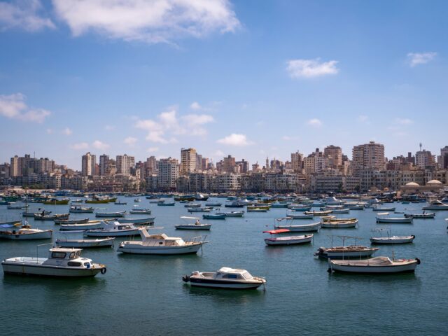 Boats on water with city skyline